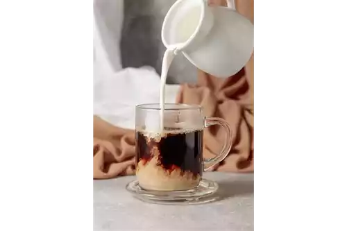 Pouring milk into espresso doesn’t impact the structure of the milk proteins, meaning they retain their original mouthfeel and taste in the final drink. Igor Normann/Shutterstock.com